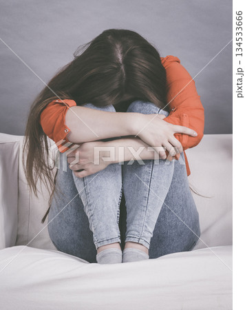 Worried woman sitting on sofa 134533666