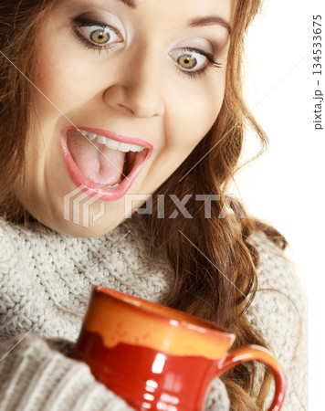 Woman holding red tea coffee mug 134533675