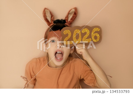 A surprised, screaming girl with the numbers 2026. Notification of the approaching New year and Christmas. The year of the fiery horse according to the Eastern calendar 134533793