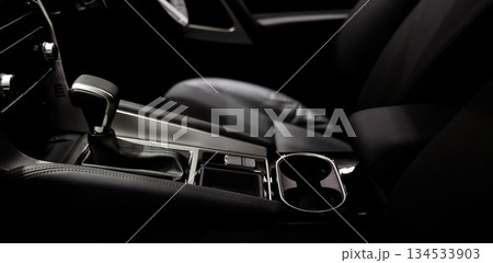 Car gear. Close up of modern car automatic gear selector or electronic shifter. Premium interior design EV car gears driving control. auto transmission modes. Automotive technology in motion driving. Car gear. Close up of modern car automatic gear selector or electronic shifter. Premium interior design EV car gears driving control. auto transmission modes. Automotive technology in motion driving. 134533903