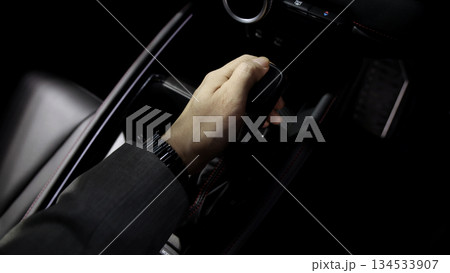 Car gear. Close up of modern car automatic gear selector or electronic shifter. Premium interior design EV car gears driving control. auto transmission modes. Automotive technology in motion driving. Car gear. Close up of modern car automatic gear selector or electronic shifter. Premium interior design EV car gears driving control. auto transmission modes. Automotive technology in motion driving. 134533907