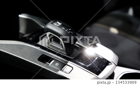 Car gear. Close up of modern car automatic gear selector or electronic shifter. Premium interior design EV car gears driving control. auto transmission modes. Automotive technology in motion driving. 134533909