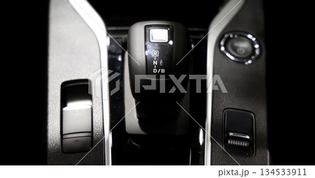 Car gear. Close up of modern car automatic gear selector or electronic shifter. Premium interior design EV car gears driving control. auto transmission modes. Automotive technology in motion driving. 134533911
