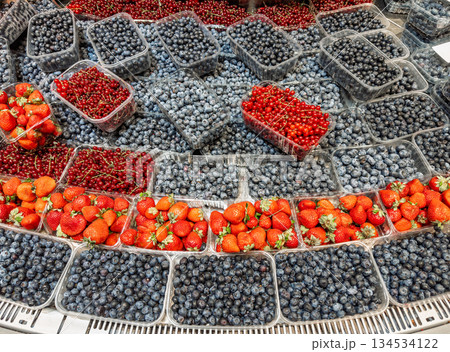 Assorted fresh berries in retail packaging blueberries, strawberries, red currants stacked neatly for vibrant grocery display and sales Assorted fresh berries in retail packaging blueberries, strawberries, red currants stacked neatly for vibrant grocery display and sales 134534122