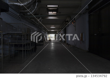 Long dark corridor in an old industrial building Long dark corridor in an old industrial building 134534792