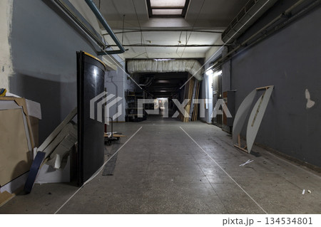 Long dark corridor in an old industrial building Long dark corridor in an old industrial building 134534801
