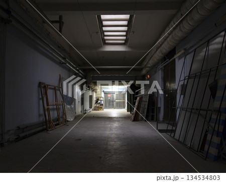 Long dark corridor in an old industrial building Long dark corridor in an old industrial building 134534803
