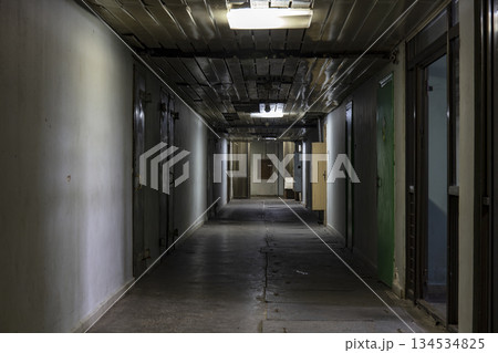 Long dark corridor in an old industrial building 134534825