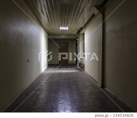 Long dark corridor in an old industrial building Long dark corridor in an old industrial building 134534826