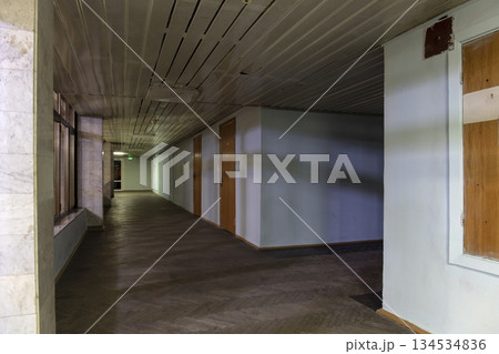 Long dark corridor in an old industrial building 134534836