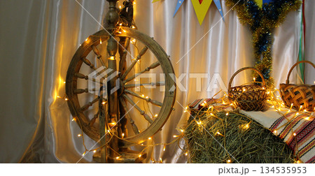 Christian Christmas symbolic antique spinning wheel, household baskets and a hayloft as symbols of Jesus' birthplace 134535953