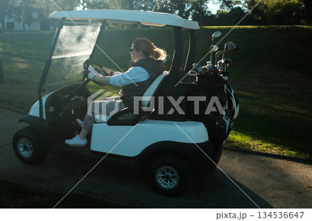 woman playing golf in the green fairway club 134536647