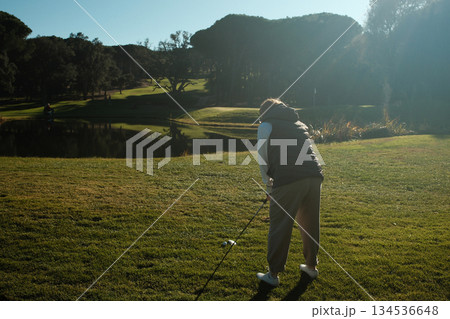 woman playing golf in the green fairway club 134536648