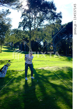 woman playing golf in the green fairway club 134537145