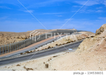 Highway and fence on the border with Egypt in the Eilat Mountains 134538831