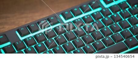 gaming keyboard with colorful RGB LED backlighting across the mechanical switches. High quality photo 134540654