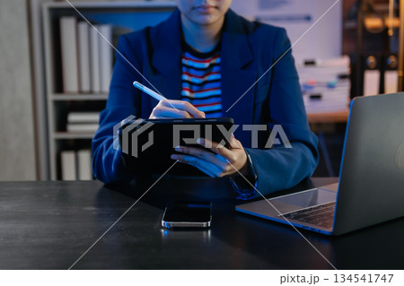 Businesswoman hand using smart phone laptop and tablet with social network 134541747