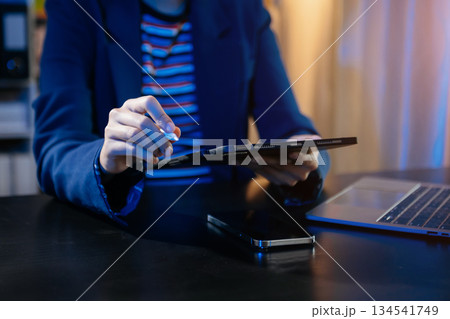 Businesswoman hand using smart phone laptop and tablet with social network 134541749
