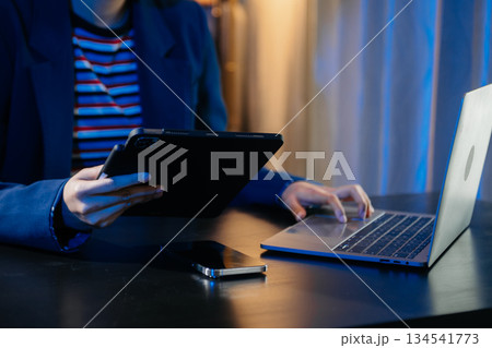Businesswoman hand using smart phone laptop and tablet with social network Businesswoman hand using smart phone laptop and tablet with social network 134541773