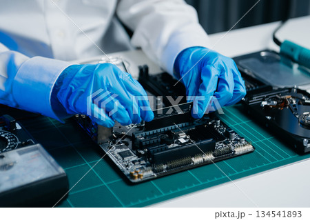 Electronics technician, electronic engineering electronic repair, electronics measuring and testing, repair and maintenance concepts.uses a voltage meter 134541893