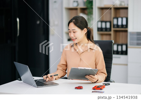 Asian people car salesman or sales manager offers to sell a car and explains of signing a car contract and signing car insurance 134541938