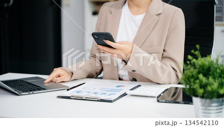 businesswoman hand working with new modern computer using on smartphone and tablet as concept 134542110