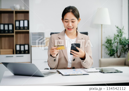 businesswoman hand using smart phone, tablet payments and holding credit card online shopping, omni channel, digital tablet businesswoman hand using smart phone, tablet payments and holding credit card online shopping, omni channel, digital tablet 134542112