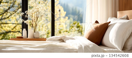 Peaceful and inviting bedroom with a large window offering a picturesque view of the surrounding nature and lush greenery 134542608