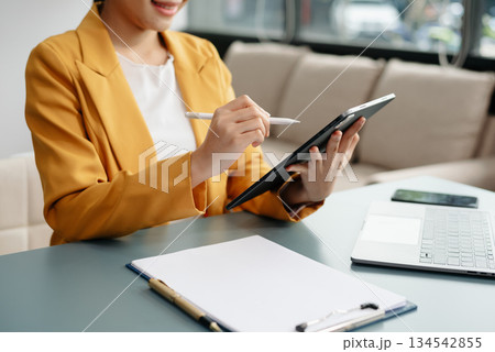 Businesswoman hand using laptop, tablet and smartphone in office. Digital marketing media mobile app and discussing plan new start up project. 134542855