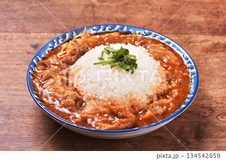 spicy sichuan-style braised beef on rice 134542859