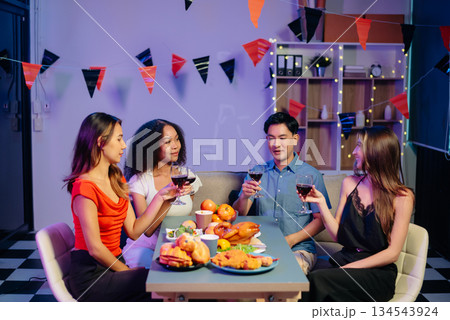 Celebration with friends enjoying food, drinks, and laughter at a lively house party. Perfect for themes of joy, togetherness, Celebration with friends enjoying food, drinks, and laughter at a lively house party. Perfect for themes of joy, togetherness, 134543924