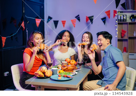Celebration with friends enjoying food, drinks, and laughter at a lively house party. Perfect for themes of joy, togetherness, Celebration with friends enjoying food, drinks, and laughter at a lively house party. Perfect for themes of joy, togetherness, 134543928