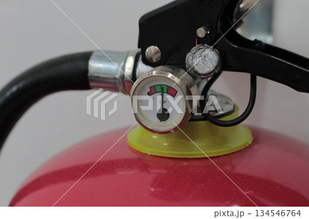 Technical close-up view of a fire extinguisher pressure dial indicating zero bar, highlighting the low charge status outside the green zone. Technical close-up view of a fire extinguisher pressure dial indicating zero bar, highlighting the low charge status outside the green zone. 134546764