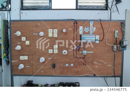 Educational mockup of domestic electrical circuit board demonstrating residential wiring schematics, including MCB, sockets, and power conversion unit. 134546775