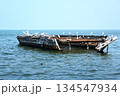 old fishing boat on the sea and white birds 134547934