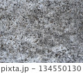 A dirty snowy surface with soil and natural particles, snow-covered asphalt. Textured background, top view. Winter season concept for design. 134550130