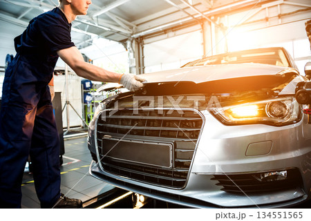 Car mechanic repair engine at service station. Car repair Car mechanic repair engine at service station. Car repair 134551565