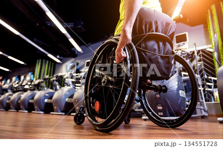 Disabled man training in the gym of rehabilitation center Disabled man training in the gym of rehabilitation center 134551728
