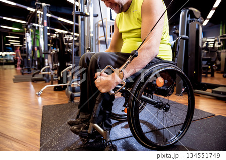 Disabled man training in the gym of rehabilitation center 134551749