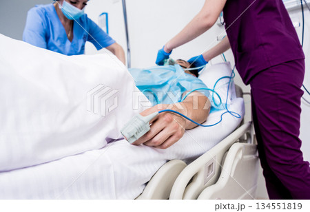 Doctors give resuscitation to a male patient in the emergency room. 134551819