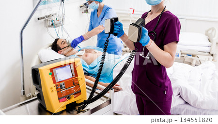 Doctors give resuscitation to a male patient in the emergency room. 134551820