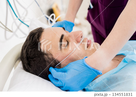 Doctors give resuscitation to a male patient in the emergency room. Doctors give resuscitation to a male patient in the emergency room. 134551831