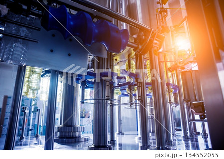 Bottling line of sunflower oil in bottles. Vegetable oil production plant. Bottling line of sunflower oil in bottles. Vegetable oil production plant. 134552055