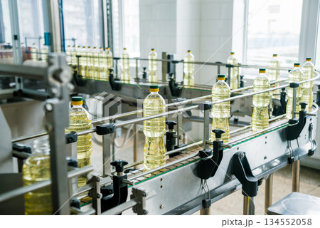 Bottling line of sunflower oil in bottles. Vegetable oil production plant. 134552058