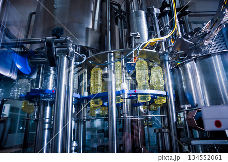 Bottling line of sunflower oil in bottles. Vegetable oil production plant. 134552061