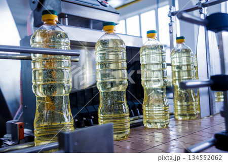 Bottling line of sunflower oil in bottles. Vegetable oil production plant. 134552062
