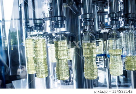 Bottling line of sunflower oil in bottles. Vegetable oil production plant 134552142