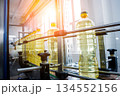 Bottling line of sunflower oil in bottles. Vegetable oil production plant 134552156