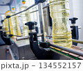 Bottling line of sunflower oil in bottles. Vegetable oil production plant 134552157