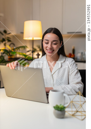 Young woman freelancer opens laptop starts work sharp eyes checks deadlines clicks trackpad evening Young woman freelancer opens laptop starts work sharp eyes checks deadlines clicks trackpad evening 134552991